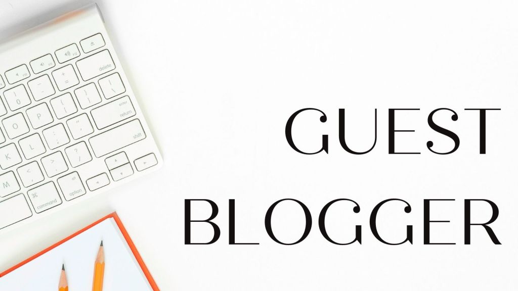 flat desk with laptop and sharpened orange pencils. Guest blogger text 