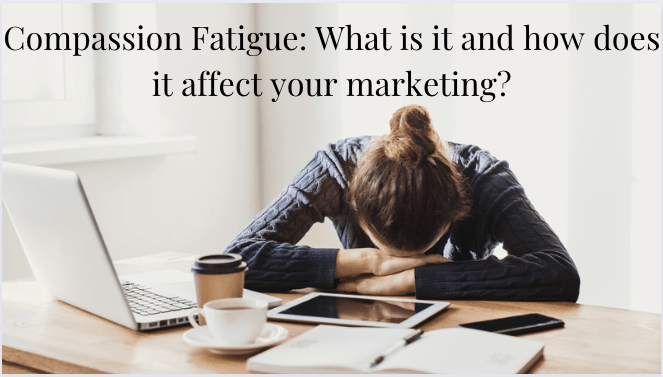 Tired and sad woman sitting at desk with forehead resting on her hands. 