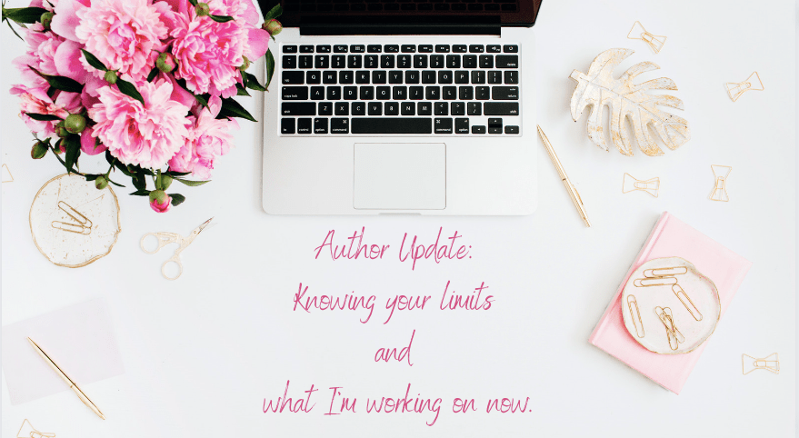 flat desk.  mac laptop, paperclips. pink flowers. text: author update: knowing your limits and what I'm working on now. 