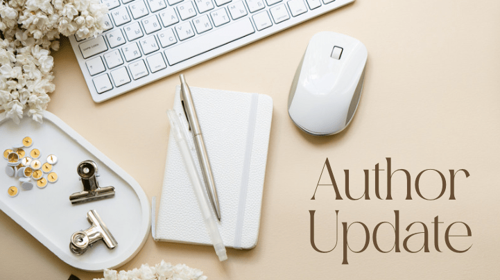 desk flatlay with flowers, paper clips, white mouse and white keyboard. text says author update