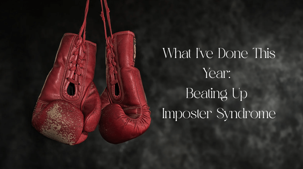 red boxing gloves hanging in front of black and grey background. 

Text says what i've done this year: beating up imposter syndrome