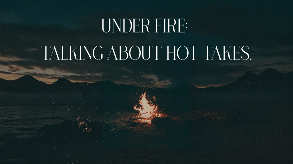 bonfire in the dark on some rocks. mountain silhouettes in background