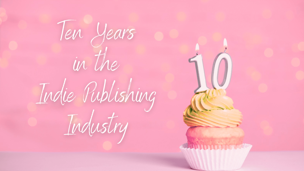 pink bokeh background. cupcake with yellow frosting. candles that have one and zero . the text says in script: ten years in the indie publishing industry